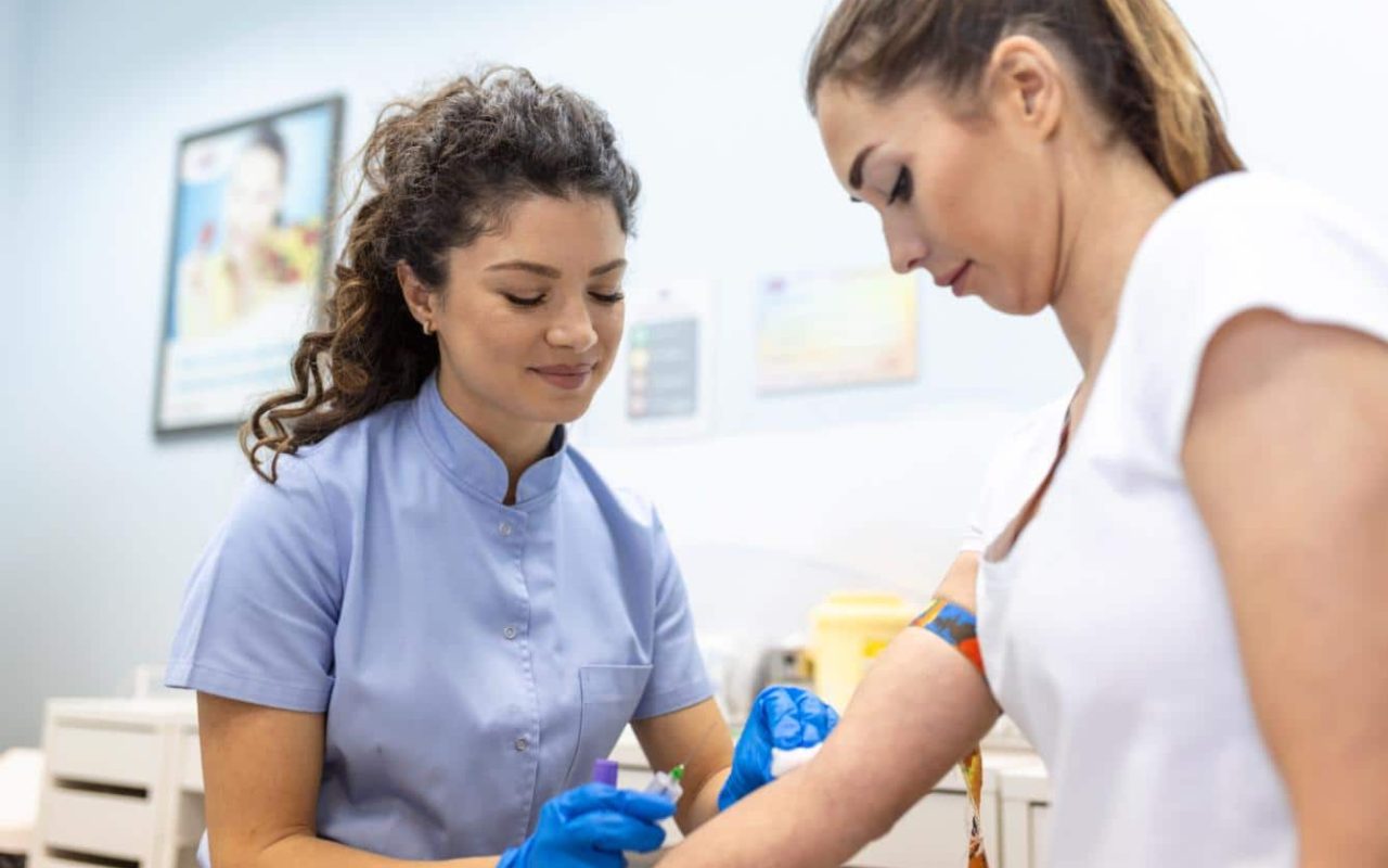 medical-technologist-doing-blood-draw-services-patient-lab-assistant-with-sterile-rubber-gloves-taking-blood-sample-from-patient (1)